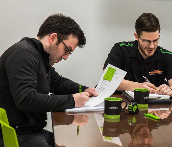 SERVPRO technicians around a table